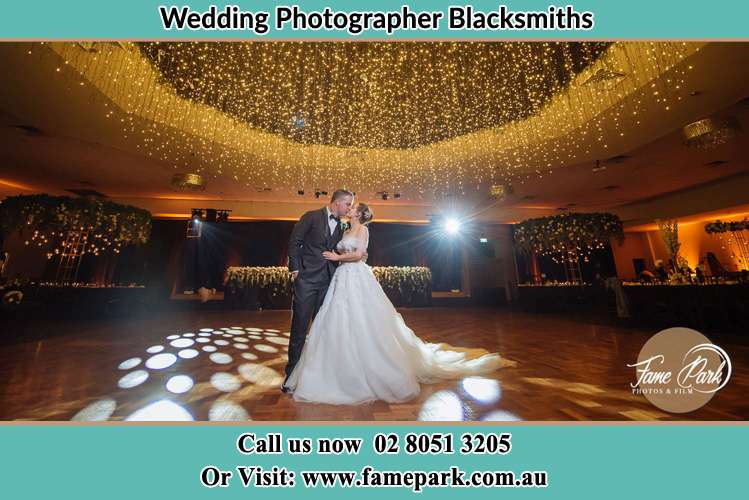 Photo of the Bride and Groom kissing at the dance floor Blacksmiths