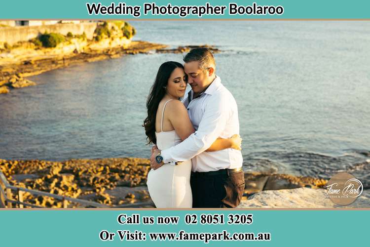 Photo of the Bride and the Groom hugging near the lake Boolaroo NSW 2284