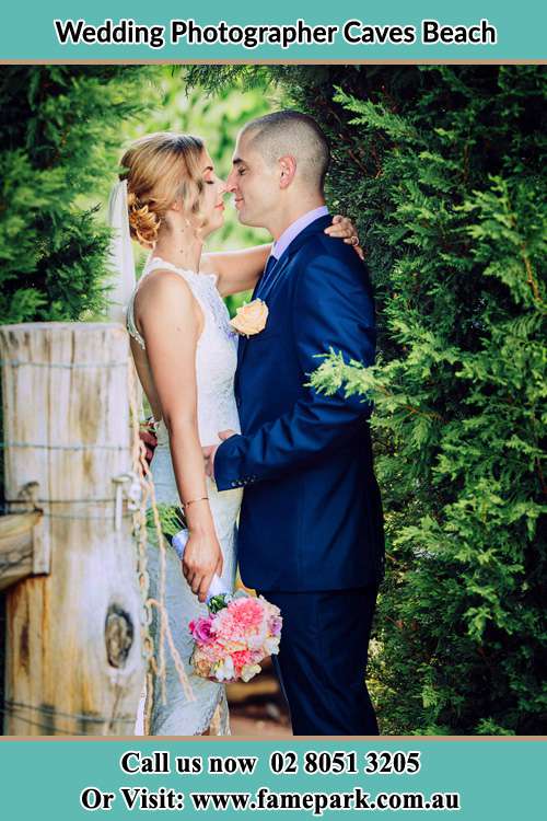 Photo of the Bride and Groom having their kissing ceremony Caves Beach NSW 2281