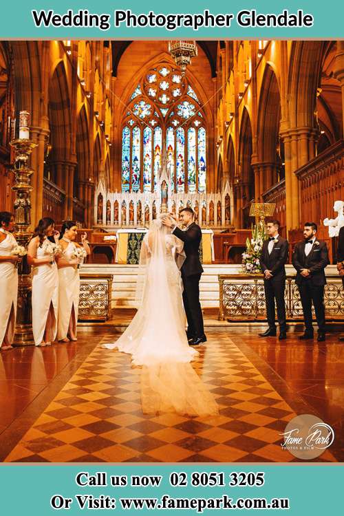 Photo of the Groom and the Bride with the entourage at the altar Glendale NSW 2285