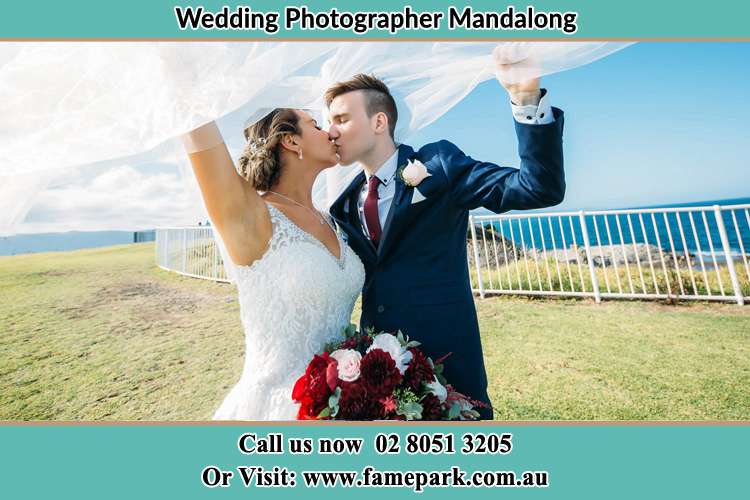 Bride and Groom kiss near the shore Mandalong