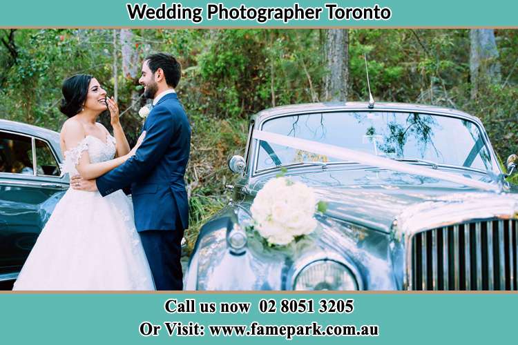 Bride and Groom beside the bridal car Toronto