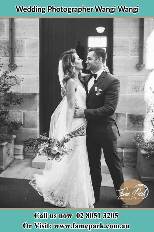 Brides and Groom hold each other in front of the house Wangi Wangi