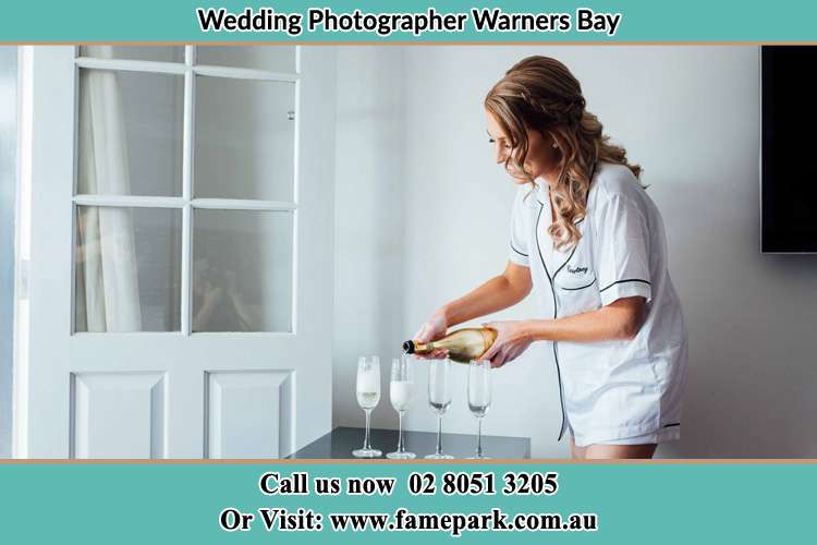 Photo of the Bride pouring wine on the glasses Warners Bay NSW 2282