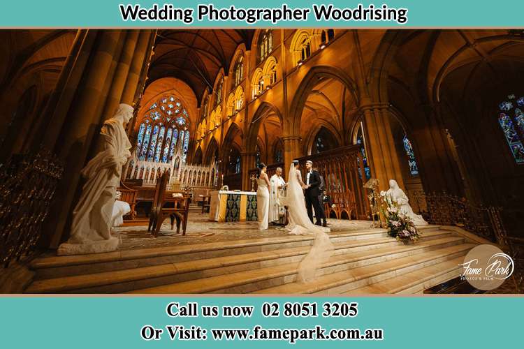 Photo of the Bride and the Groom at the altar Woodrising NSW 2284